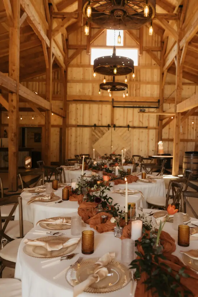 Rustic wedding reception setup inside the timber-framed Barn Owl Venue in Valleyford, Washington